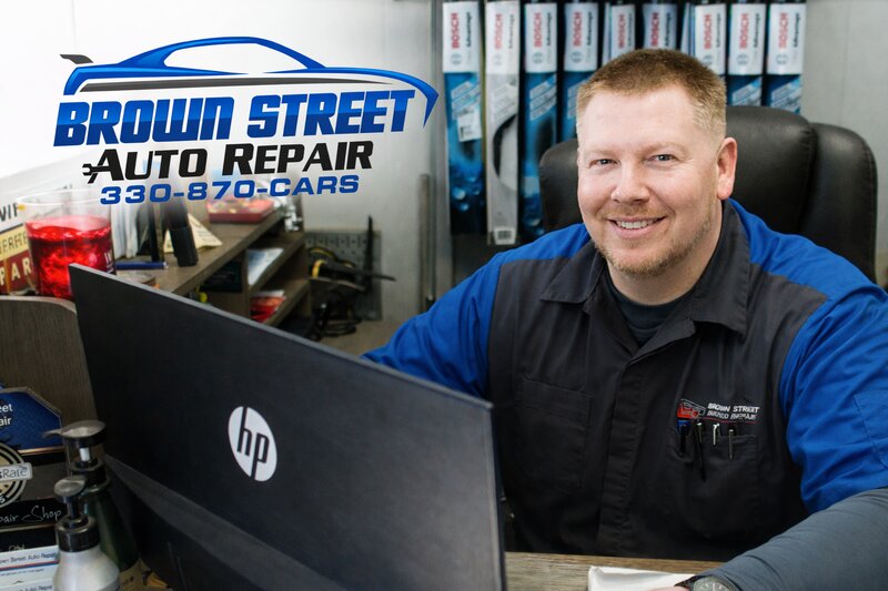 Mike owner of Brown Street Auto Repair at his desk in Akron Ohio